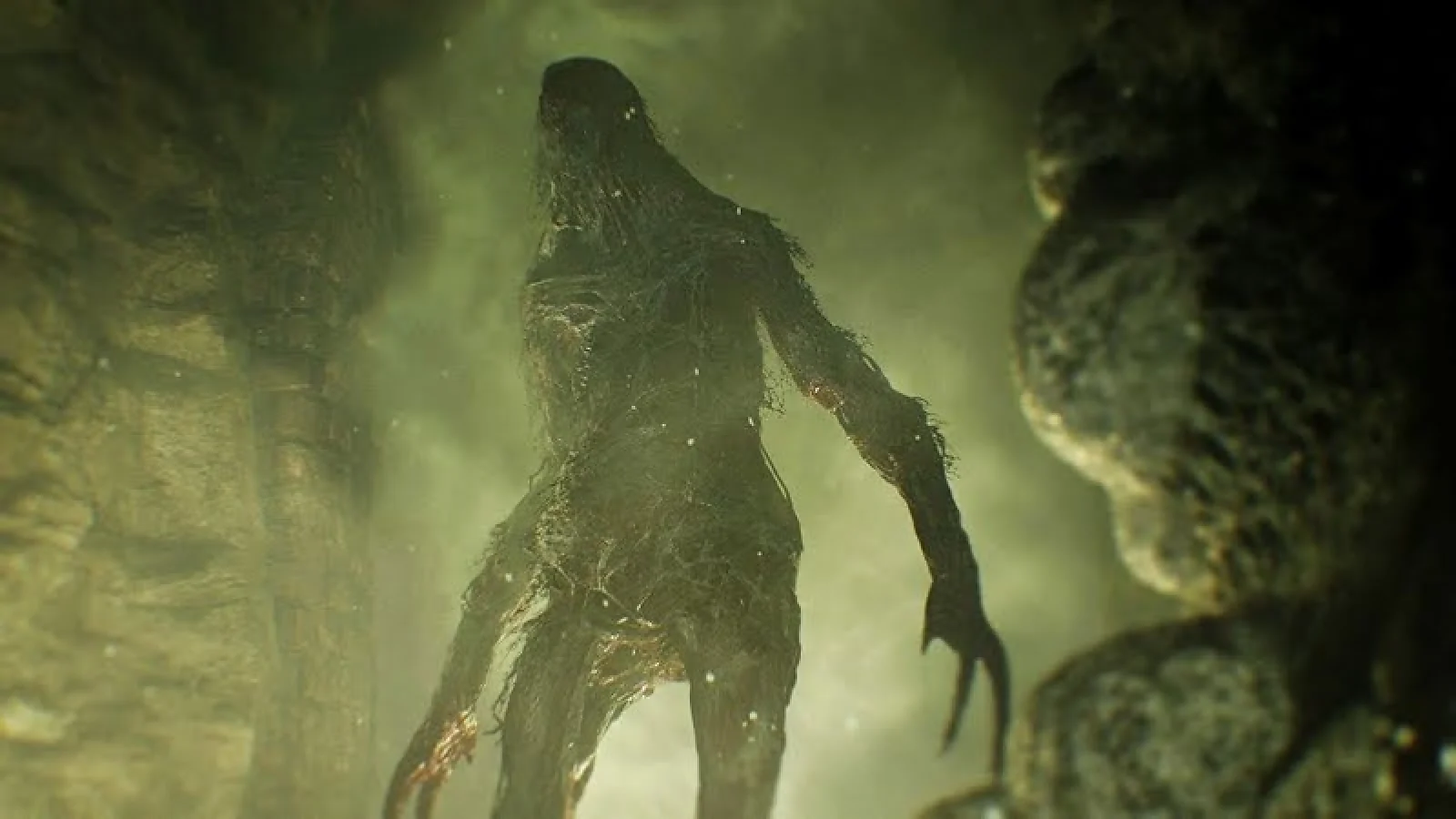 Molded creature emerging in a dark area