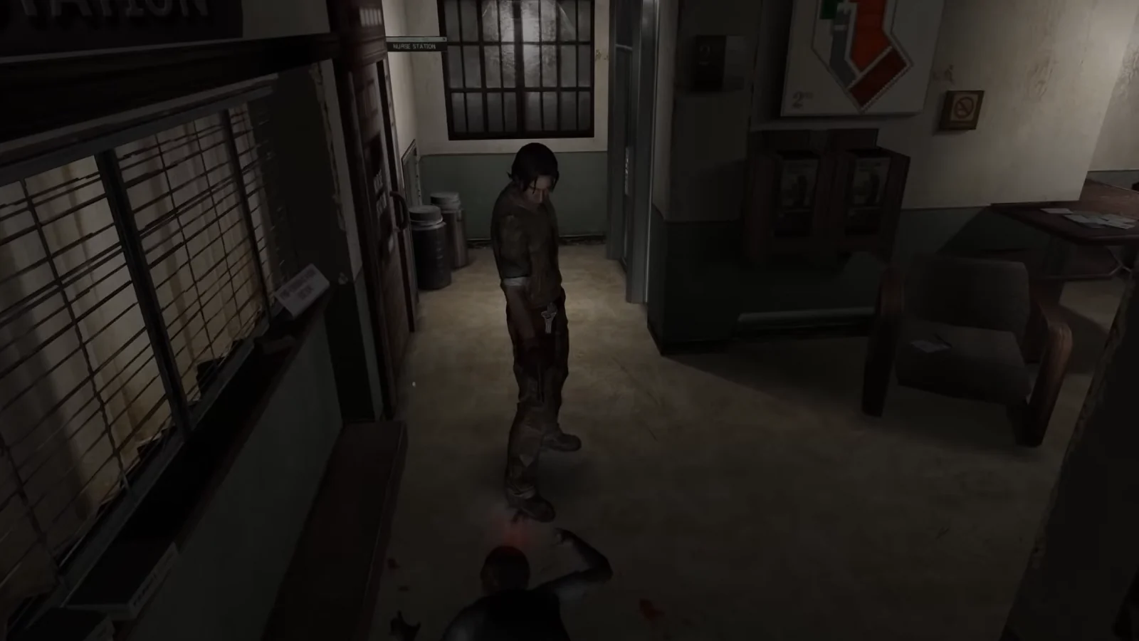 A survivor stands inside a dim office beside a fallen body.