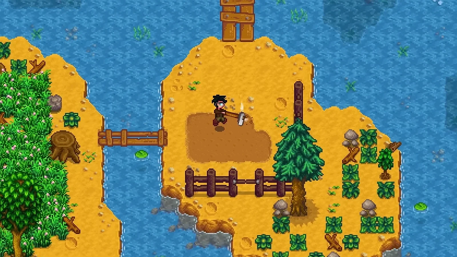Stardew Valley farmer tills soil with a hoe on a sandy island surrounded by water